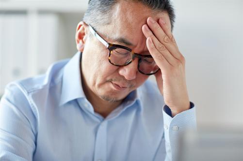 businessman-suffering-from-headache-at-office-PZS7